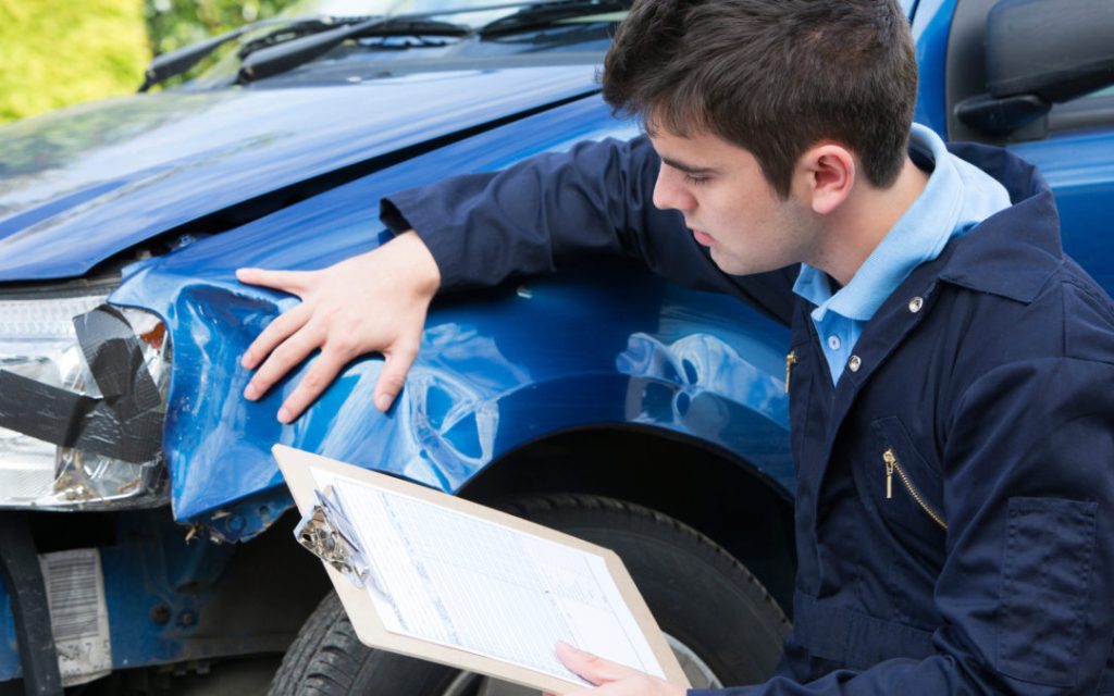 nairi-auto-body-Mechanic Inspecting Car And Filling In Repair Estimate-nairiautobody